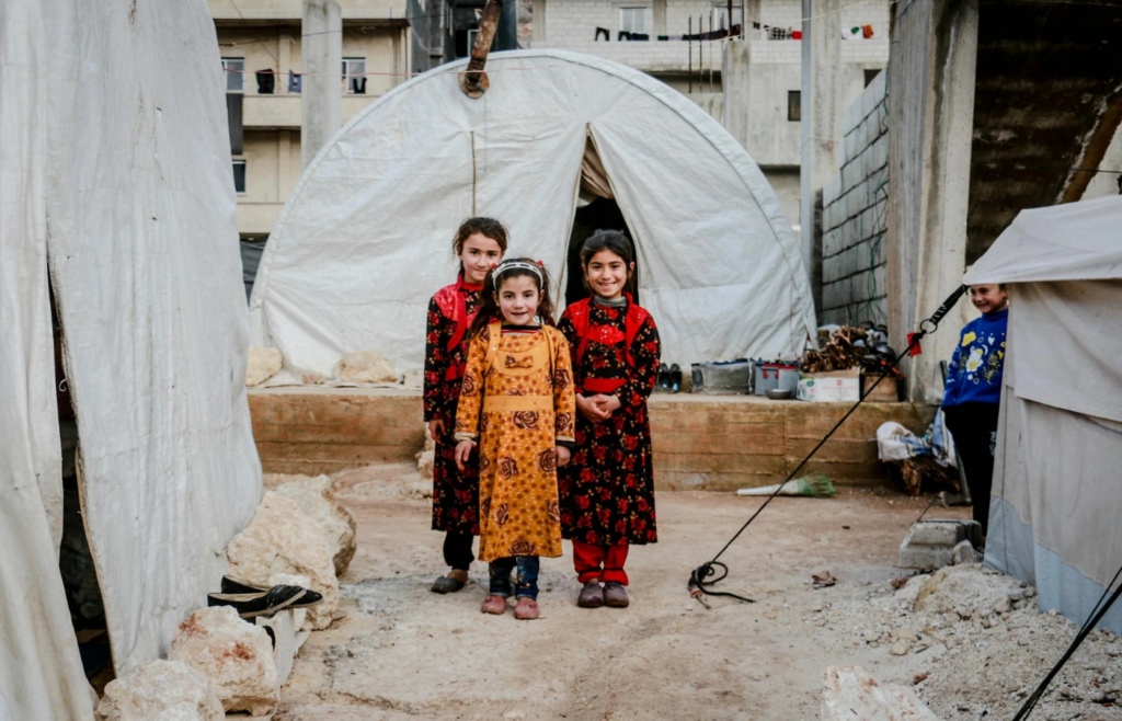Kids of family posing in front of shelter