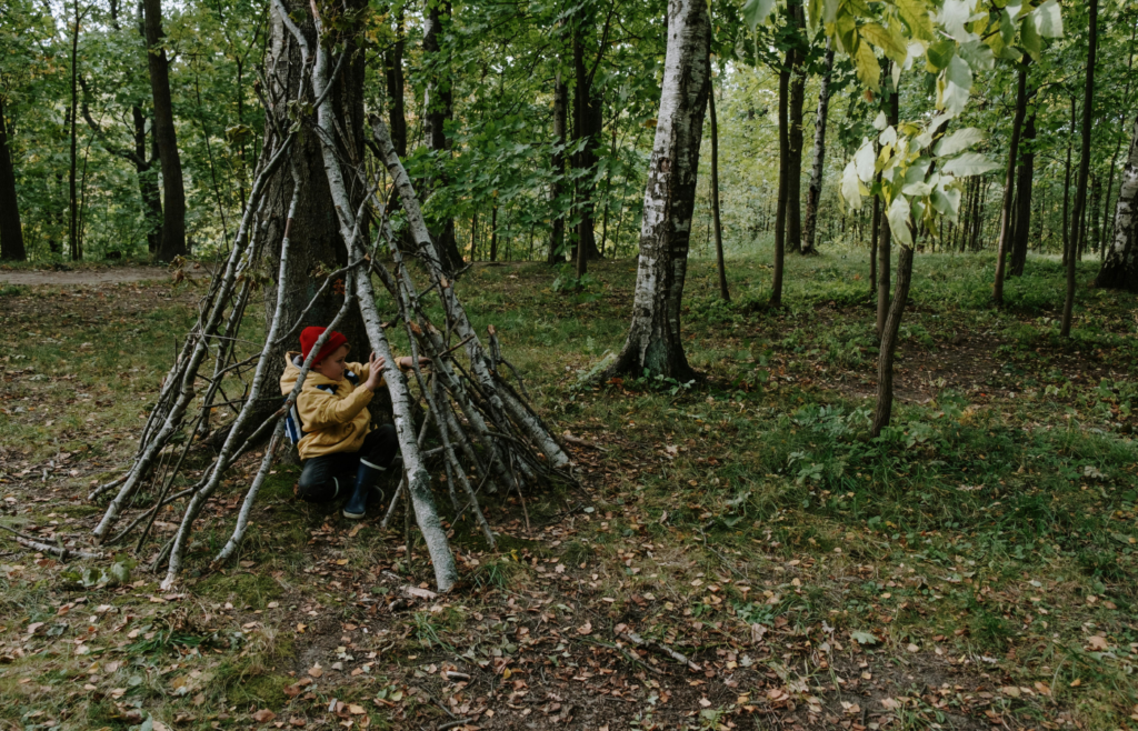 A Boy Hiding Behind the Wooden Sticks