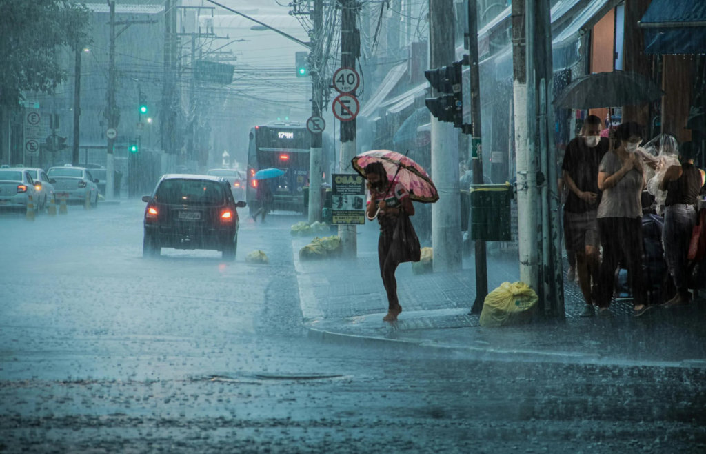 People walking in heavy rain in city