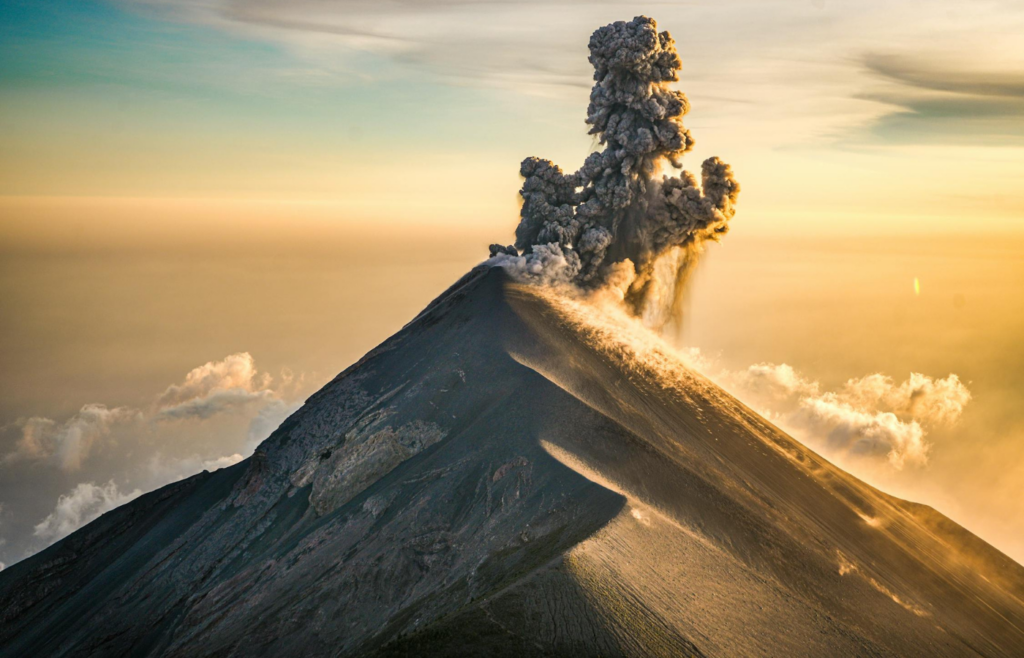 An erupting volcano spewing ash into the atmosphere