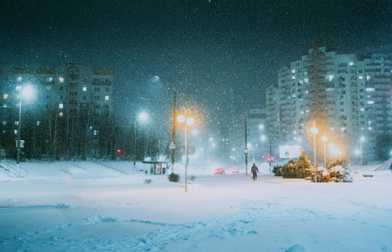 A winter storm rapidly rolling in over a town