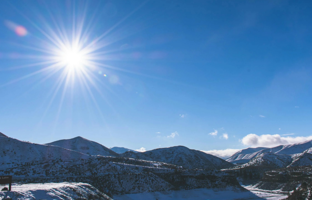 A clear sky with the sun positioned high