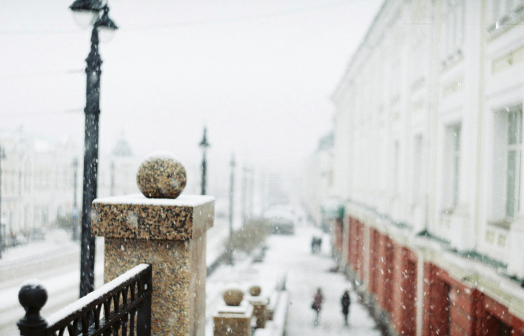 Snow falling in an urban setting with surprised pedestrians