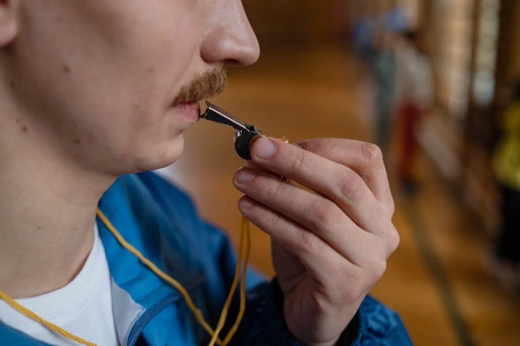 Person ready to blow a whistle