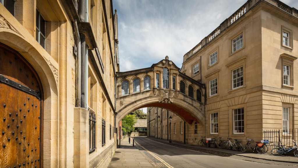 Historic stone bridge connecting buildings in university setting
