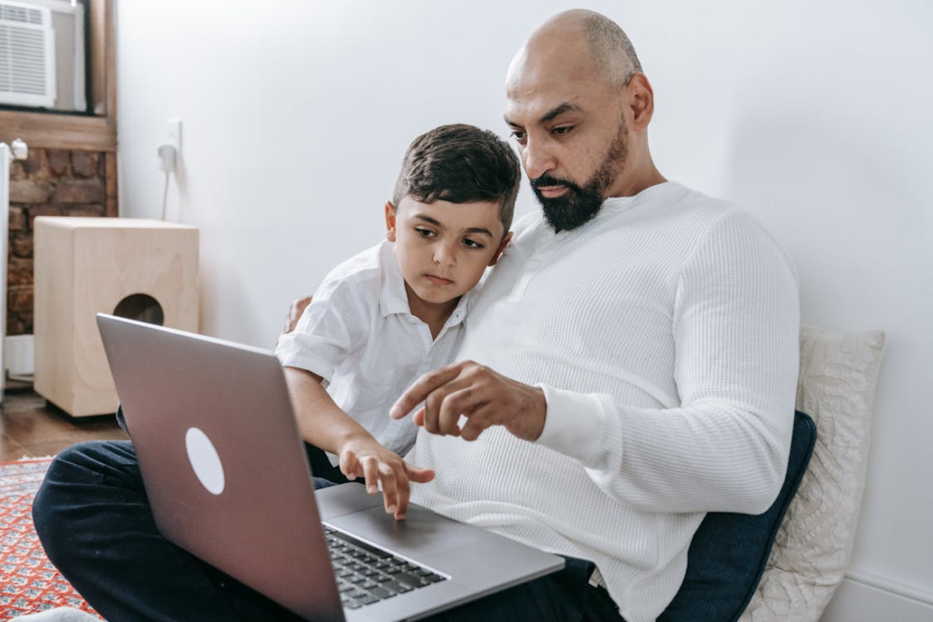 Father teaches son by sitting on the floor