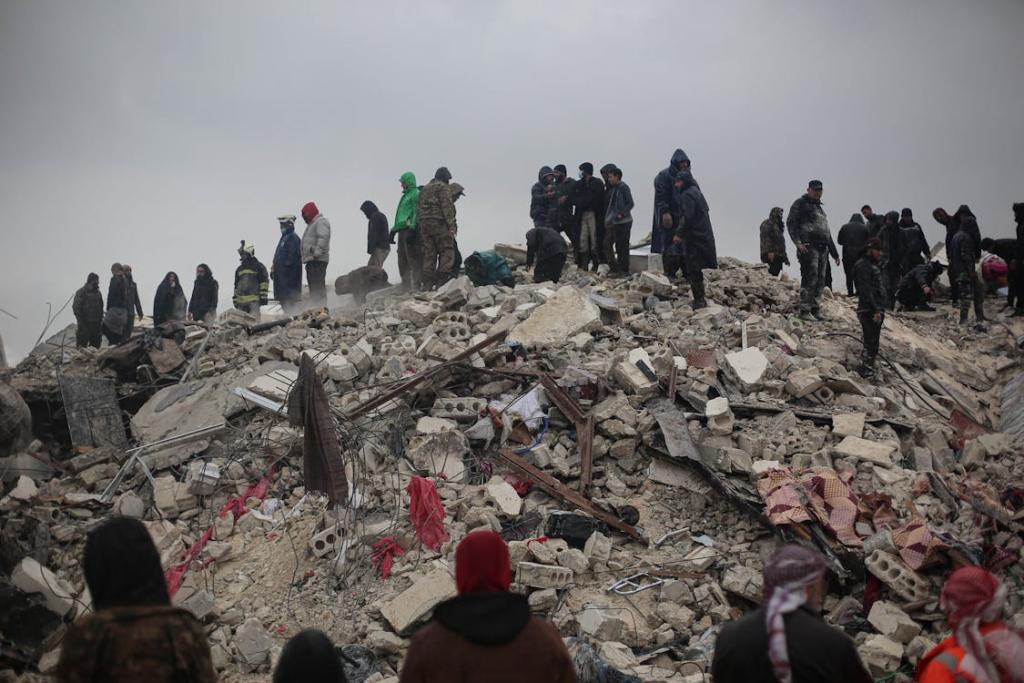 Many people are walking over a broken house