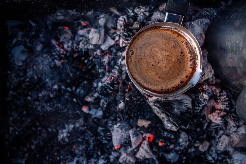 Rustic Coffee Brewing over Outdoor Campfire