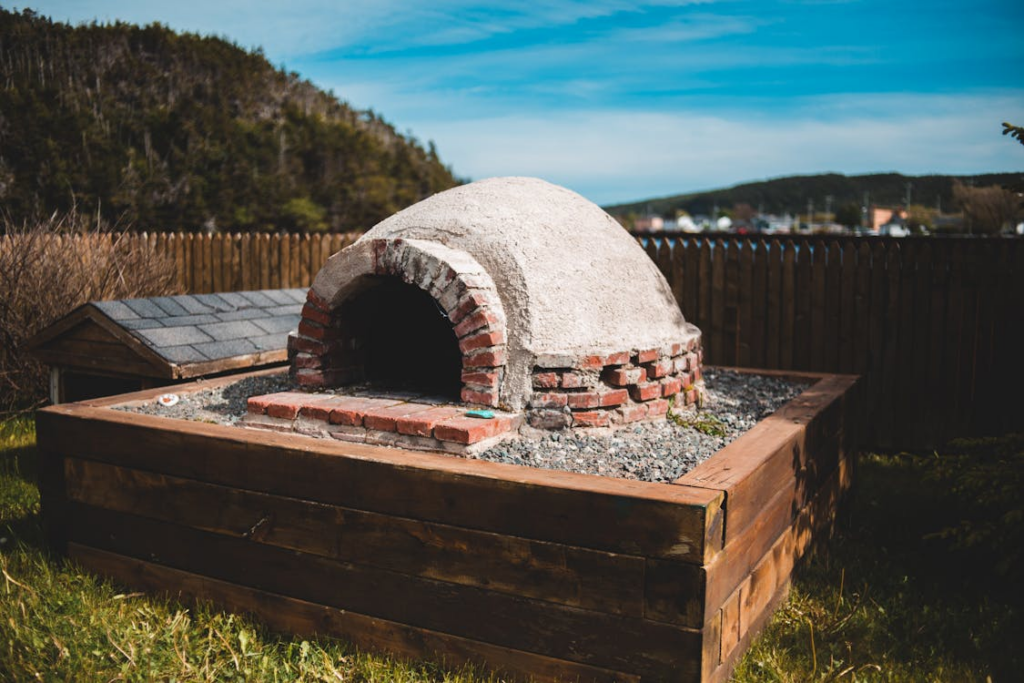 Outdoor oven near wooden fence