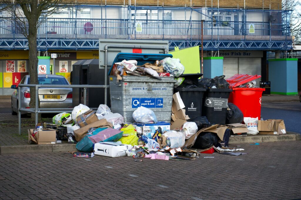 Overflowing garbage bins on a street