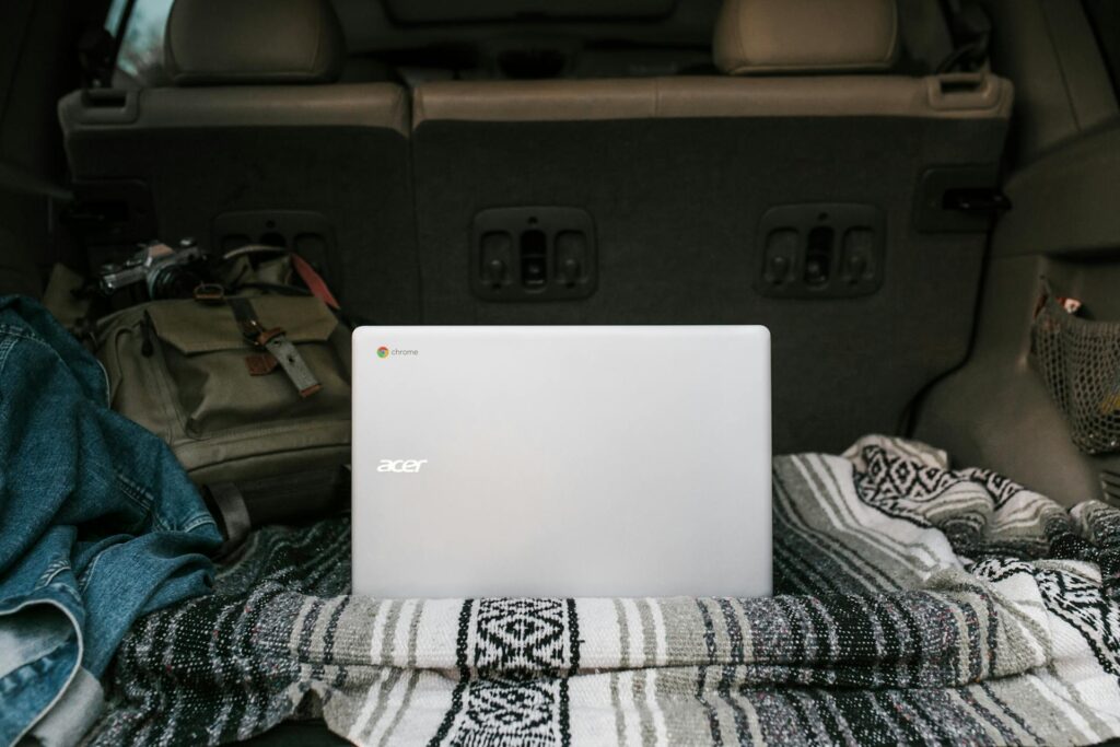 laptop and blanket inside car